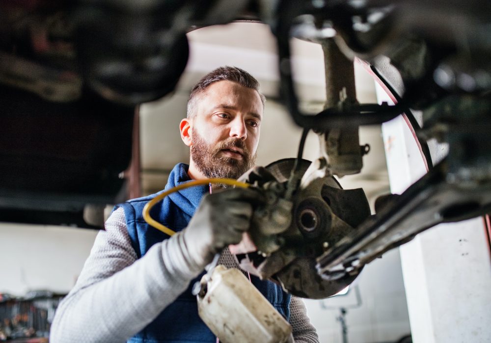 man-mechanic-repairing-a-car-in-a-garage-.jpg